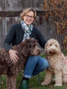 Suzanne Goodwin outside with two cobberdogs